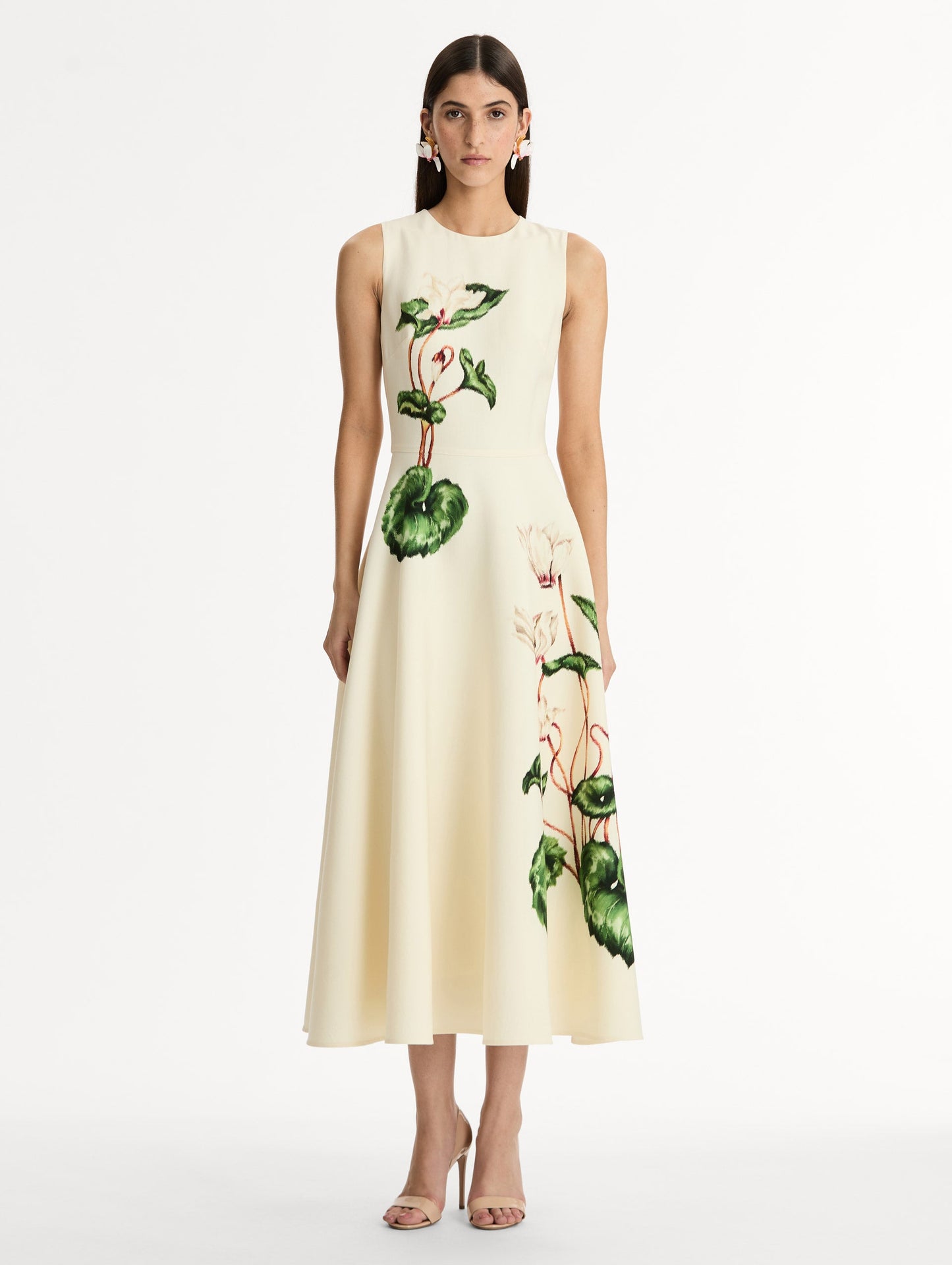 Halter Neck, Sleeveless midi dress with fitted bodice and flared midi skirt. Chiné Cyclamen motif on soft ivory background with blurred edges. Front View.