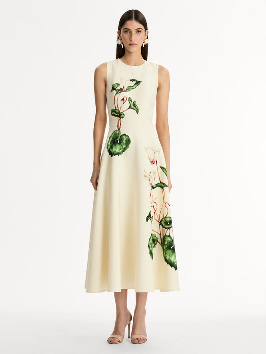 Halter Neck, Sleeveless midi dress with fitted bodice and flared midi skirt. Chiné Cyclamen motif on soft ivory background with blurred edges. Front View.