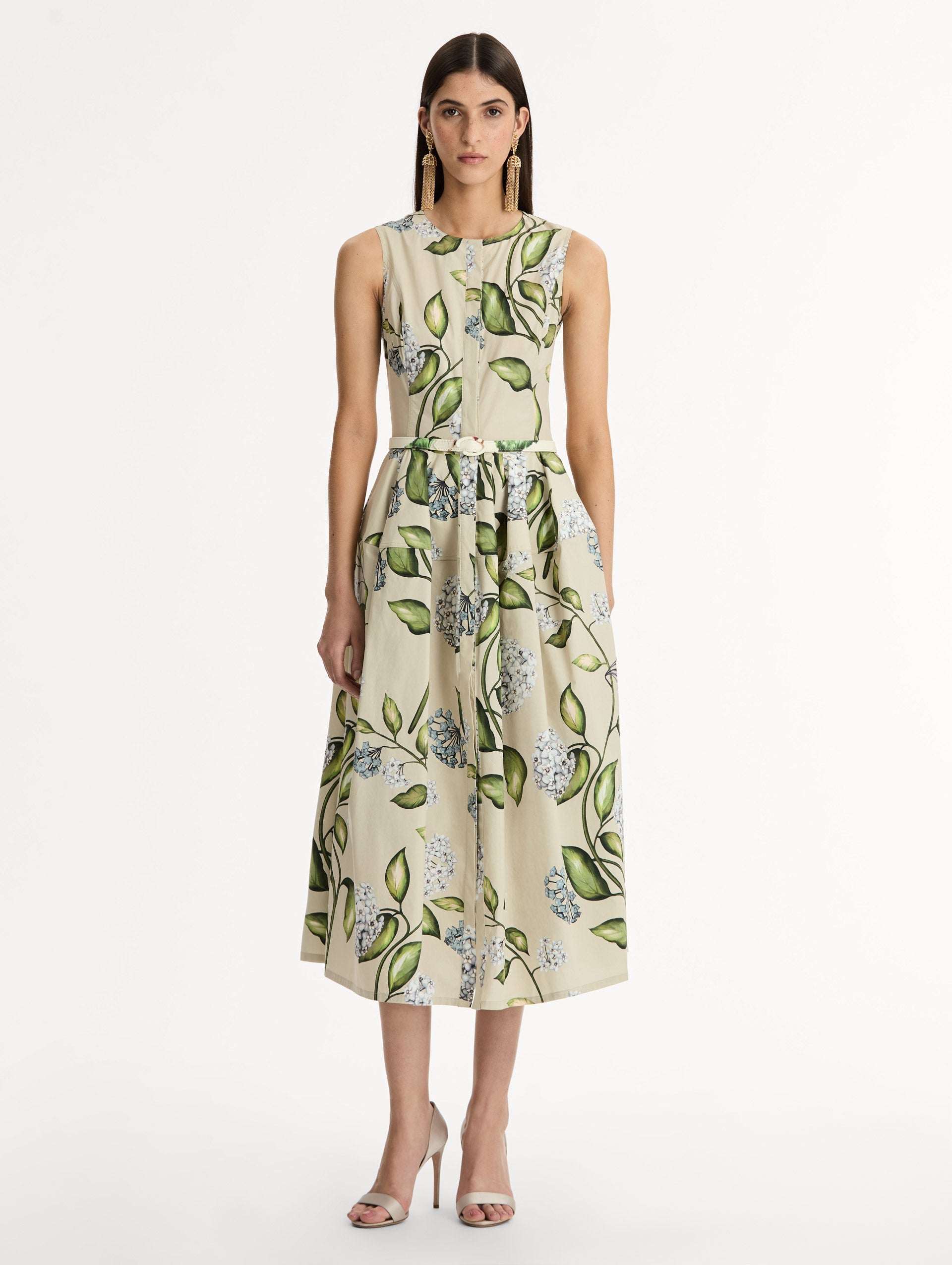 Porcelain Flower Cotton Poplin Dress This cotton poplin dress. Clean, sculpted lines. Relaxed, mid-length silhouette. with cinching matching self-belt at the waist. Front View.