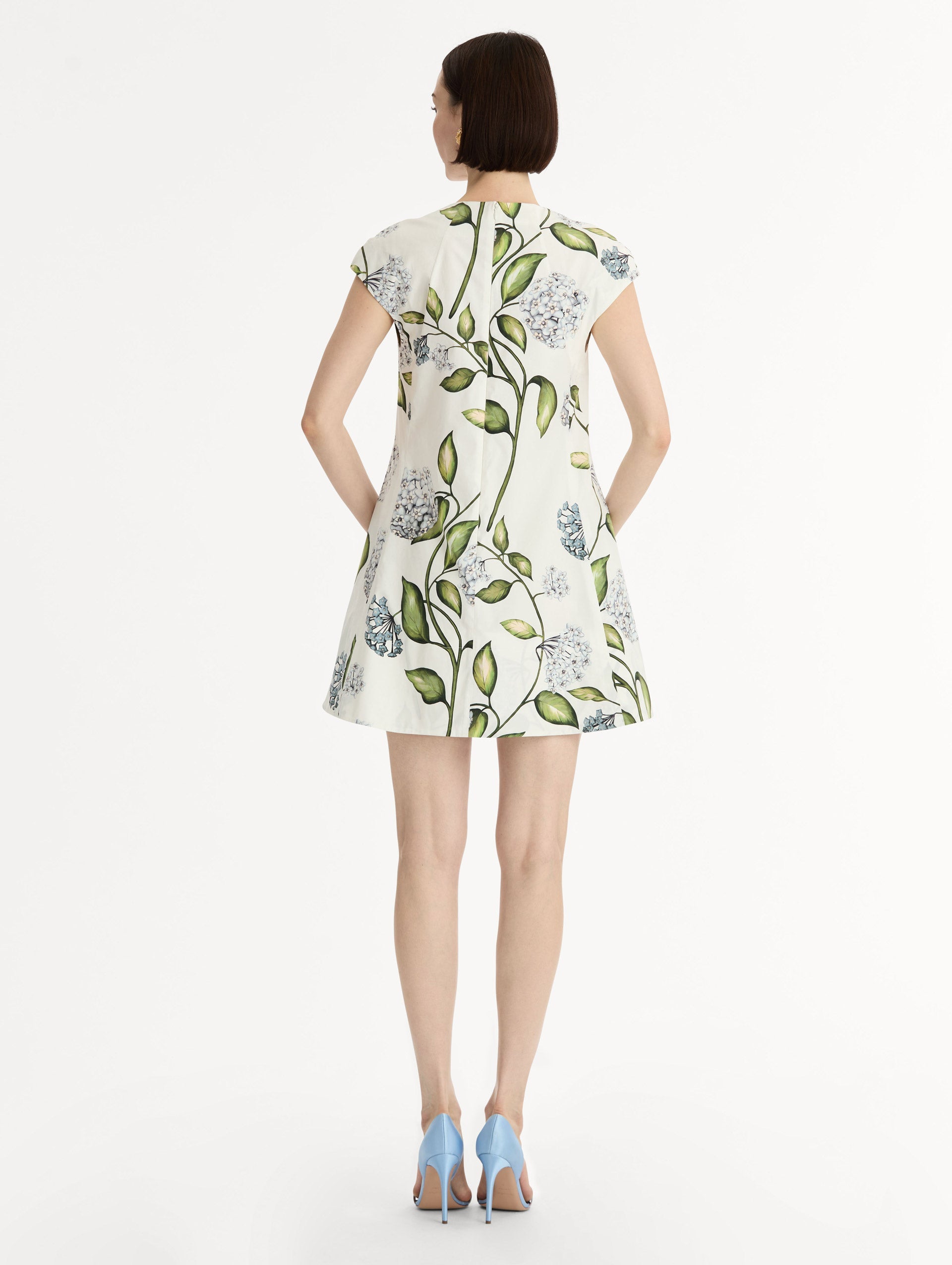 Porcelain Flower Cotton Poplin A-Line Mini Dress. Short Sleeves. Blue and Green Floral Motif. Back View.