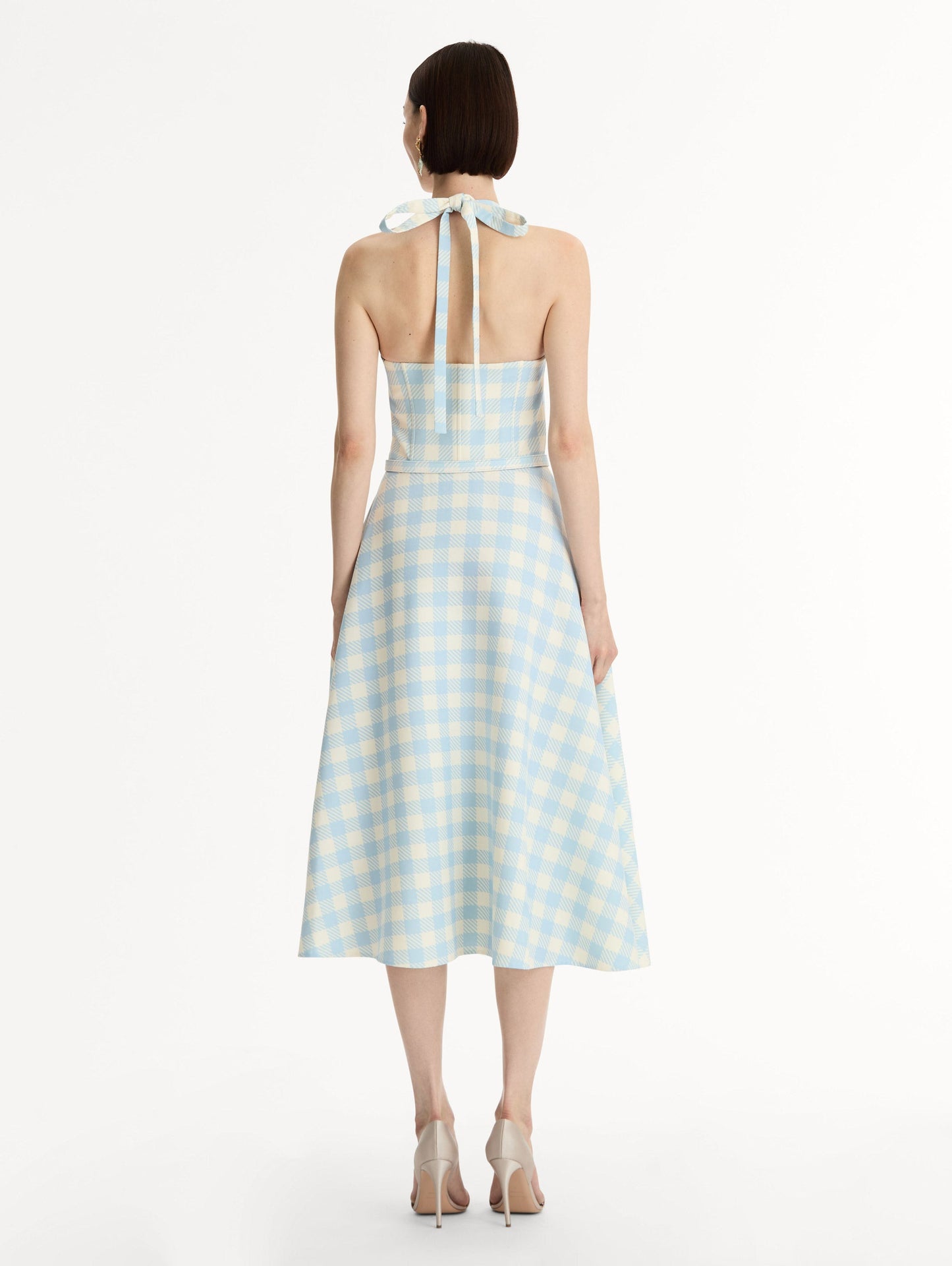 Pale blue and ivory gingham wool-blend halter dress. Structured bodice, flared midi skirt, and covered belt at the waist. Back View.