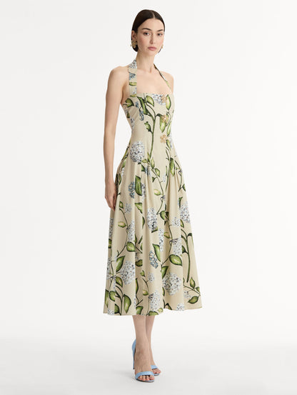 Cotton Poplin Halter Neck Midi Dress. Three Gold Floral Buttons at Front. Blue and Green Florals. Side View.