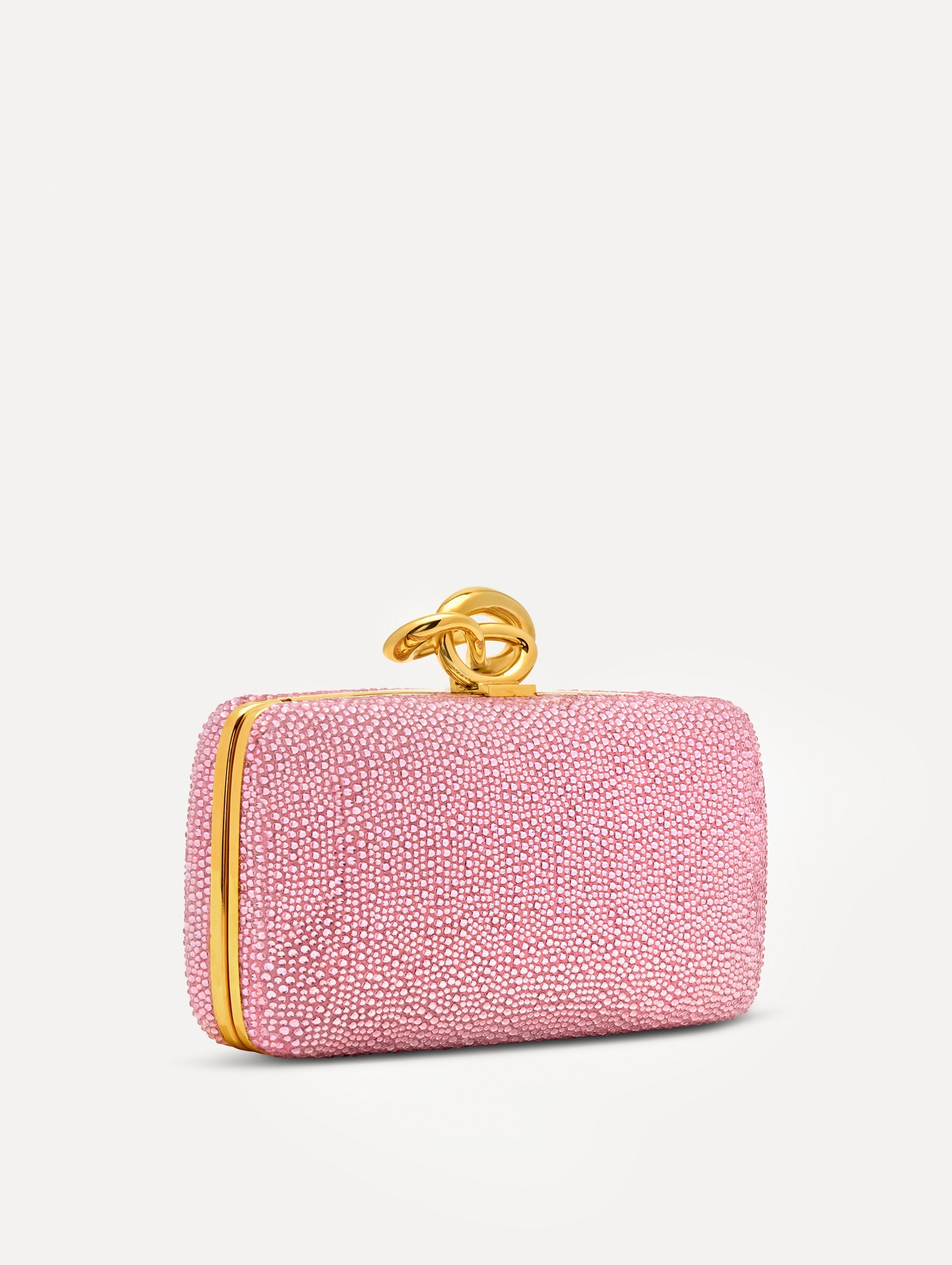 Pink Crystal Pavé Knot Minaudière featuring a rectangular silhouette, allover pavé embellishment, and sculptural gold knot clasp.