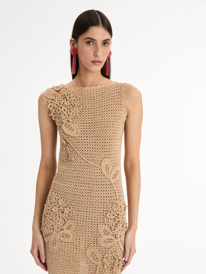 Taupe, halter neck mini dress with tonal porcelain flowers across an intricate hand-crocheted lattice, sculpted petals winding along the body. Front View, Close Up.