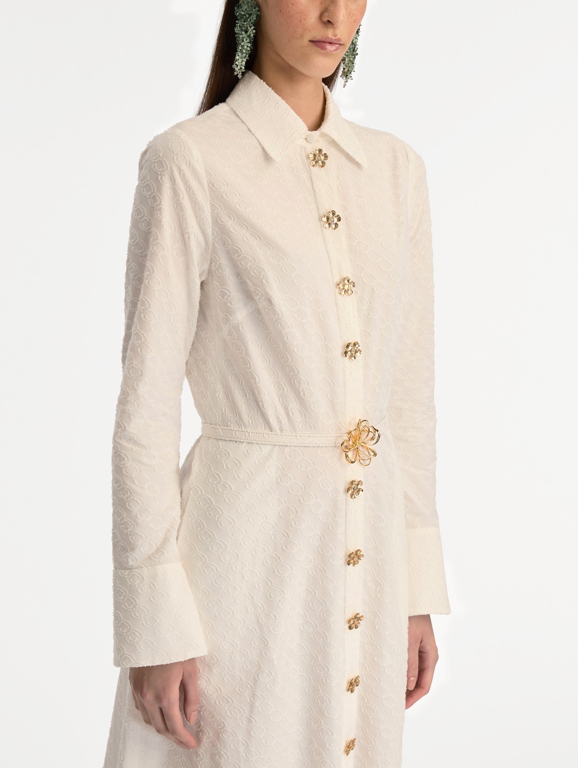 Ivory Oscar Chain-Link Cotton Poplin Caftan featuring a collared neckline, flared sleeves, gold button front, and belted waist with floral buckle. Zoom View.