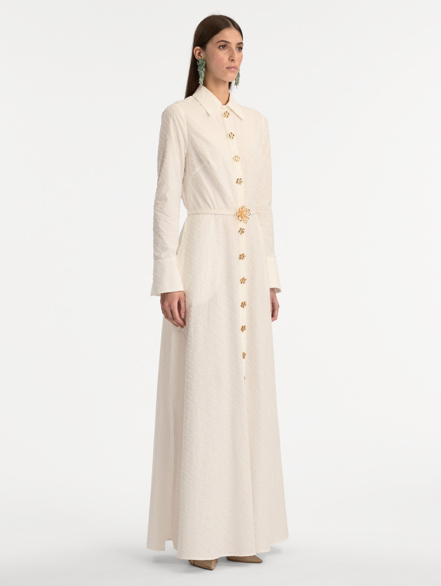 Ivory Oscar Chain-Link Cotton Poplin Caftan featuring a collared neckline, flared sleeves, gold button front, and belted waist with floral buckle. Side View.