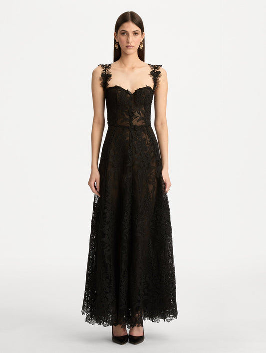 Black Foxglove Guipure Cocktail Dress featuring a fitted bodice with structured cups, lace straps, and a sheer lace overlay skirt. Front View.