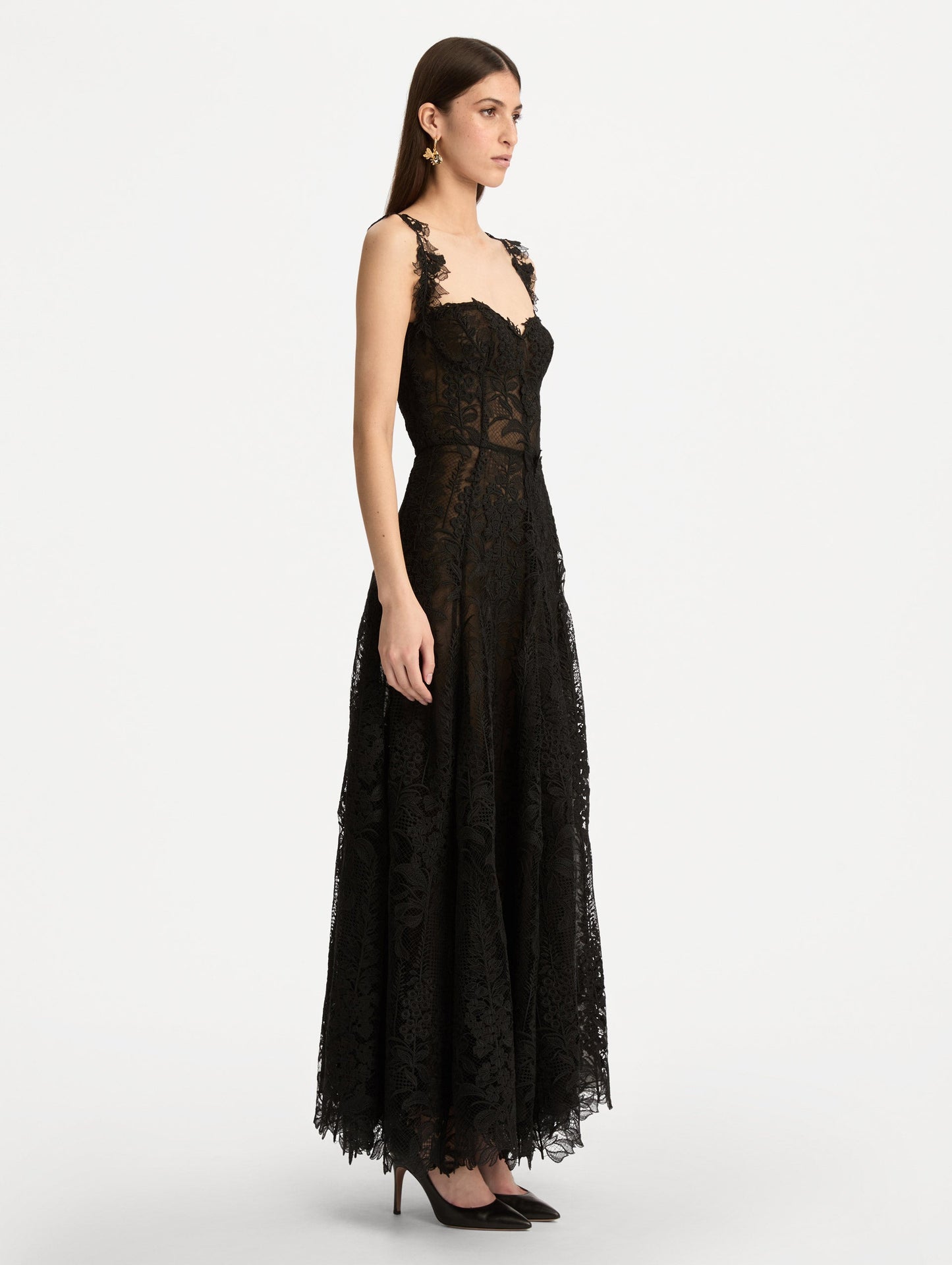 Black Foxglove Guipure Cocktail Dress featuring a fitted bodice with structured cups, lace straps, and a sheer lace overlay skirt. Side View.