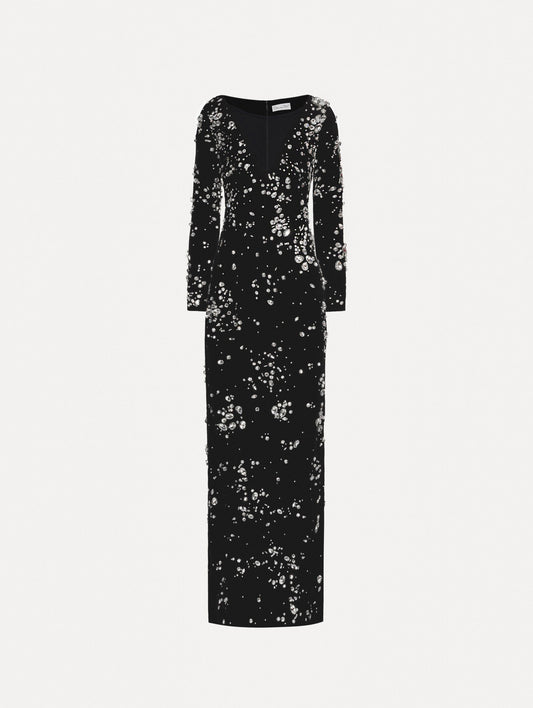 Long sleeve black gown with multi-dimensional stones scattered across the dress, features plunging V-neckline and column silhouette.
