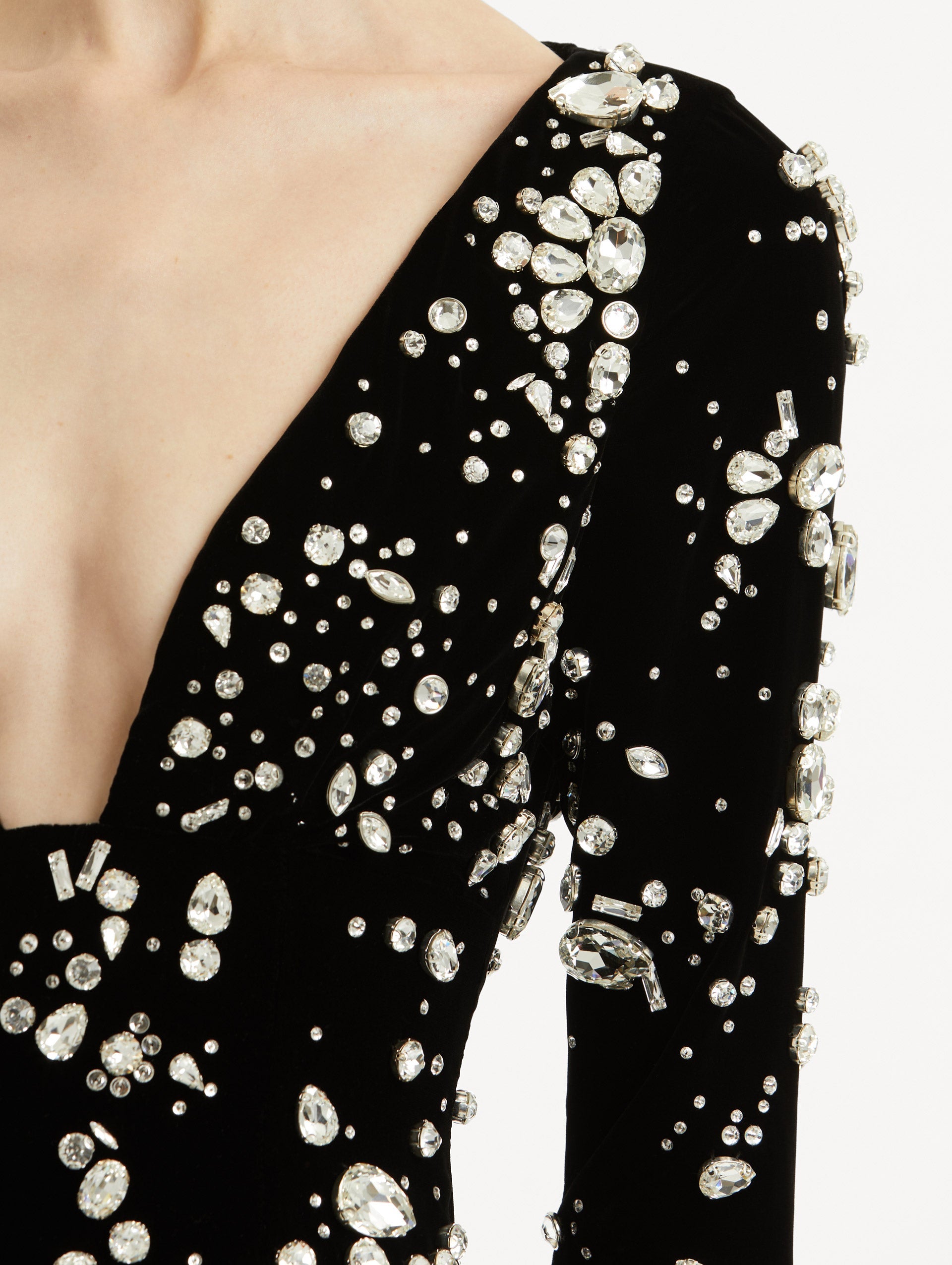 Zoomed in image of plunging V-neckline with scattered multi-dimensional stones.