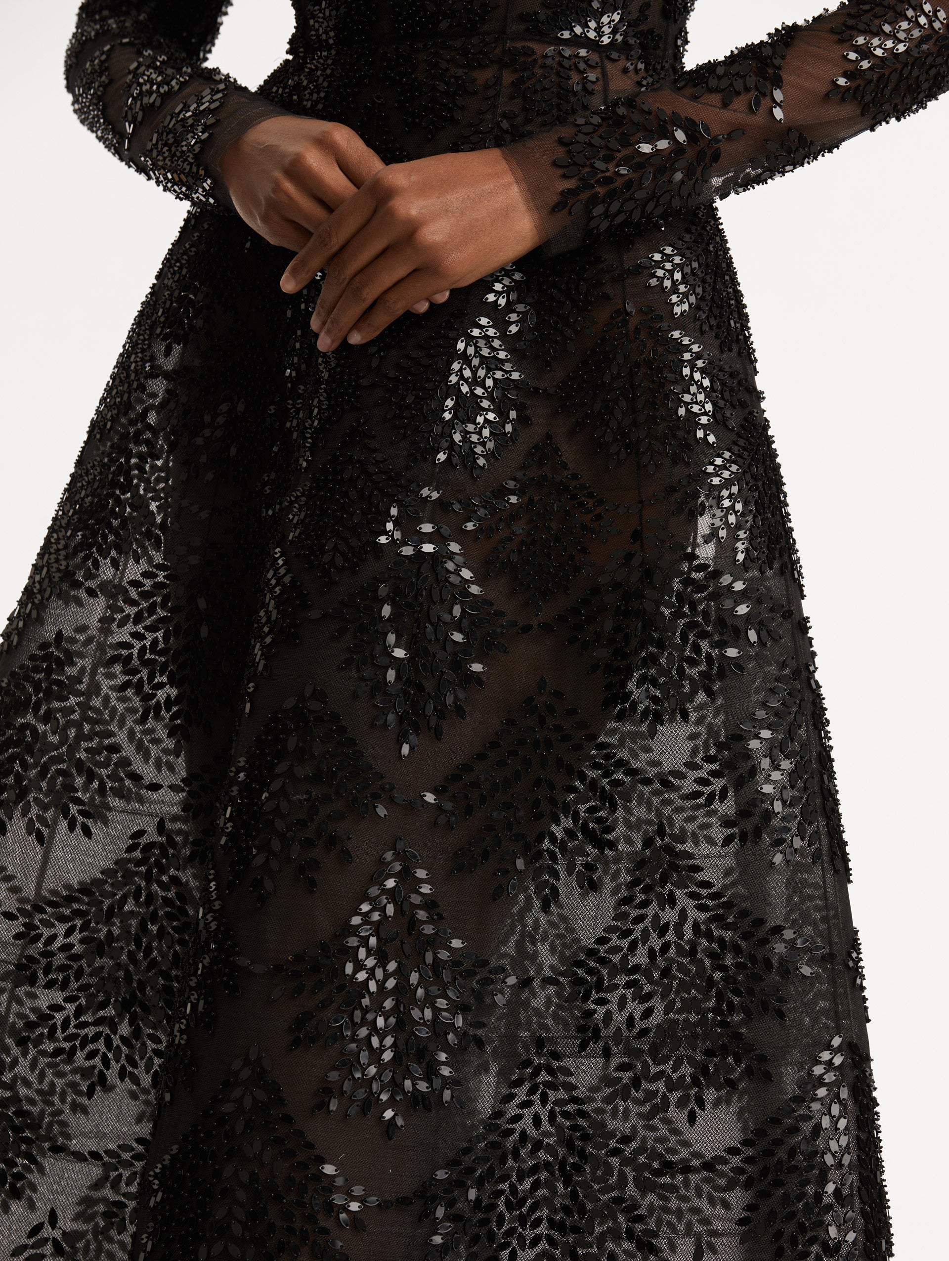 Zoomed in image of softly flared skirt with black sequin fern embroidery against the tulle base