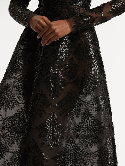 Zoomed in image of softly flared skirt with black sequin fern embroidery against the tulle base