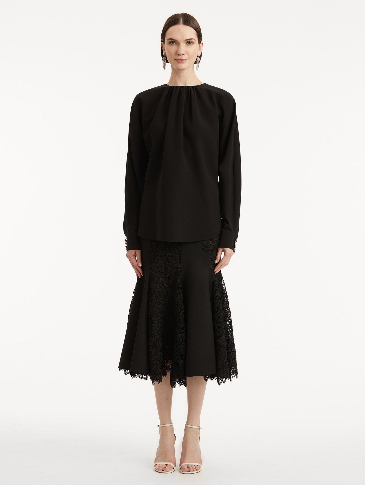 full body front view of model wearing black long sleeve top.