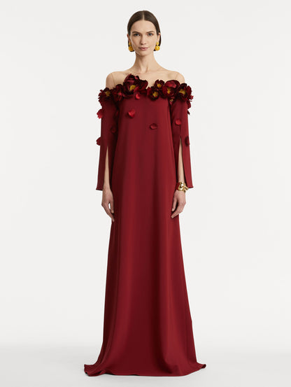Full body front view of model wearing red split sleeve caftan with peony appliqués.