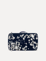 Clutch with multi-dimensional crystal embroidery and faceted stones scattered across canvas. The clutch features the Oscar ‘O’ emblem at the clasp.