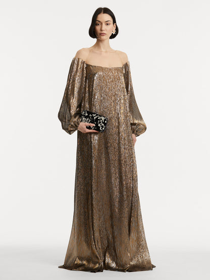 Full body image of model holding clutch with multi-dimensional crystal embroidery and faceted stones scattered across canvas.