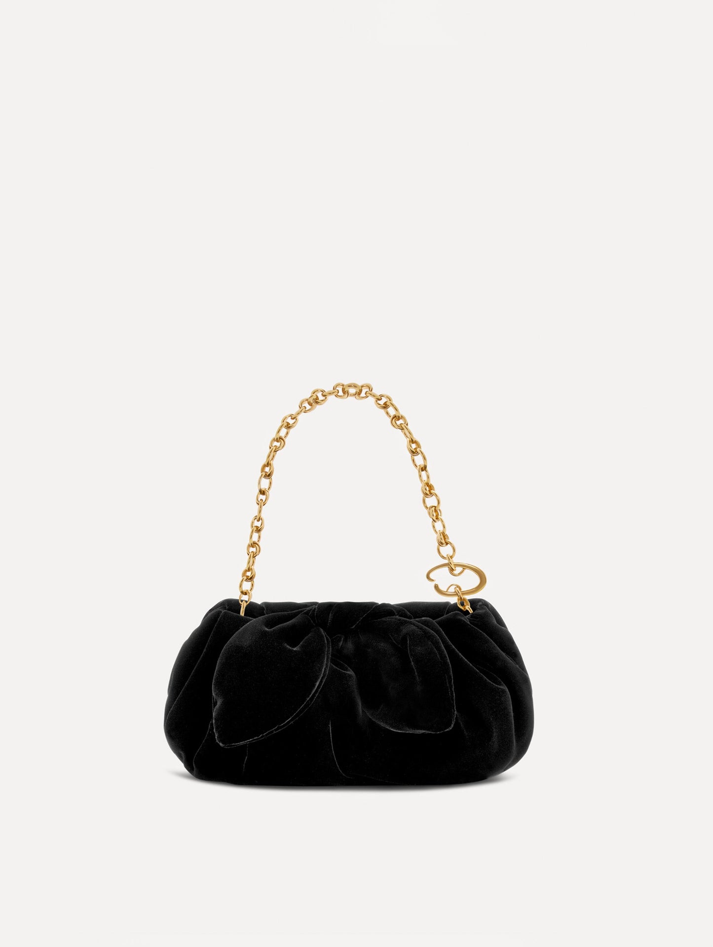 Front view of The Velvet Clutch in black which features fabric folding, where the velvet is gathered and secured with a voluminous bow. While a gold chain lends a modern contrast.