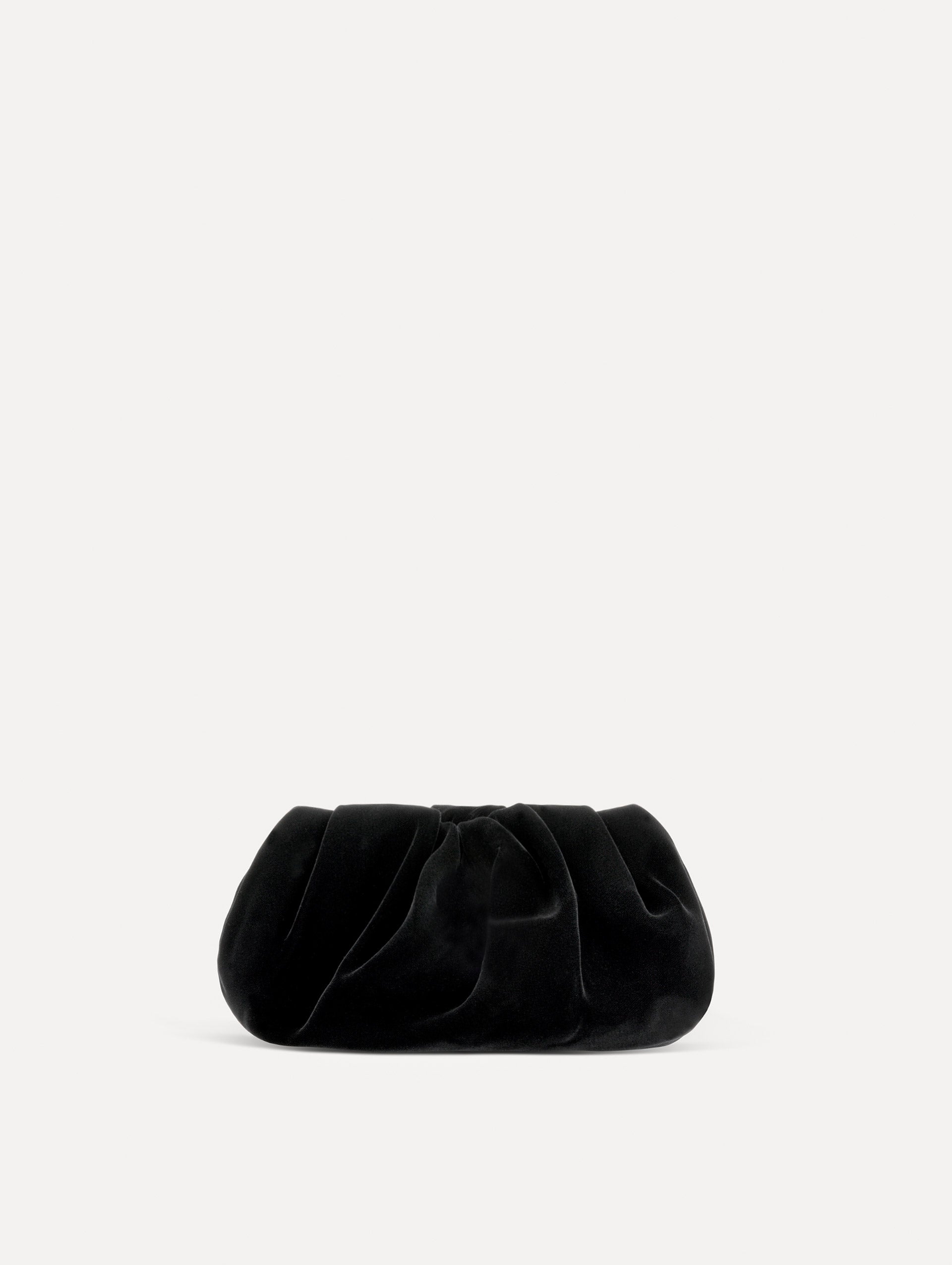 Back view of The Velvet Clutch in black features fabric folding, where the velvet is gathered.