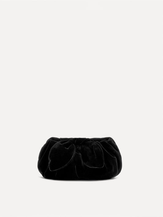 The Velvet Clutch in black features fabric folding, where the velvet is gathered and secured with a voluminous bow.