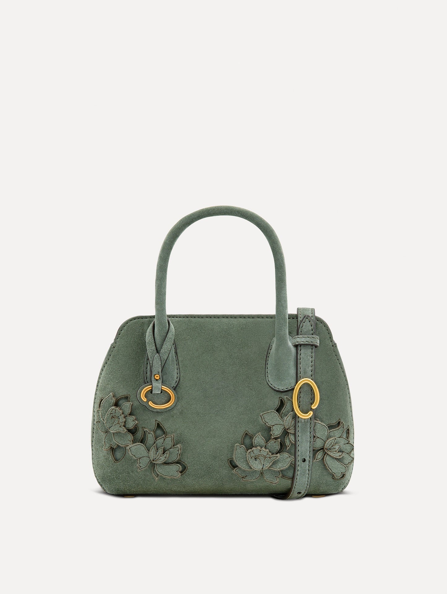 The Mini Ivy With Laser Cut Flowers in sage has a compartment with top handles and a removeable shoulder strap with various Oscar 'O' emblems on the hangtag and magnetic closure.