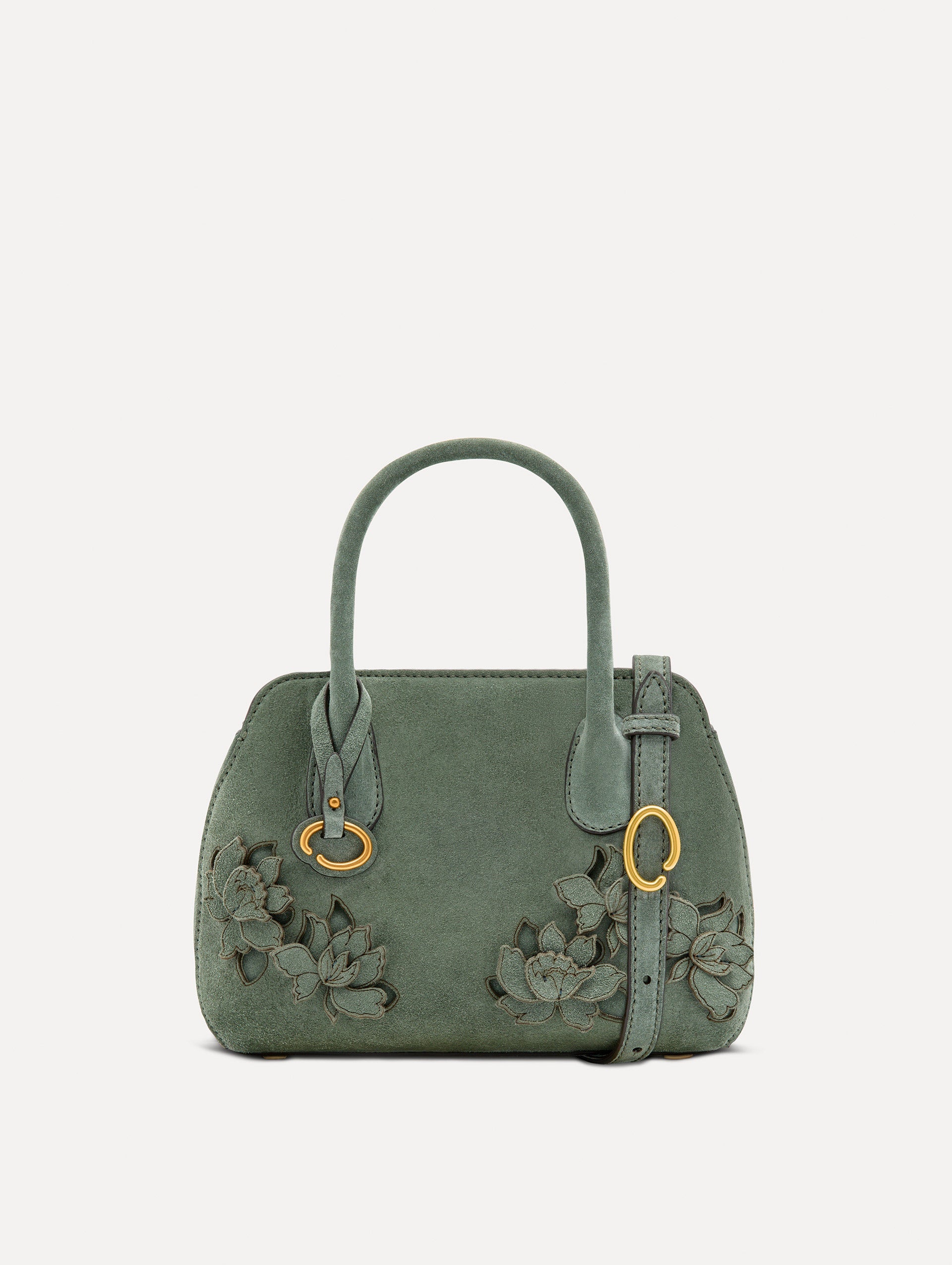 The Mini Ivy With Laser Cut Flowers in sage has a compartment with top handles and a removeable shoulder strap with various Oscar 'O' emblems on the hangtag and magnetic closure.