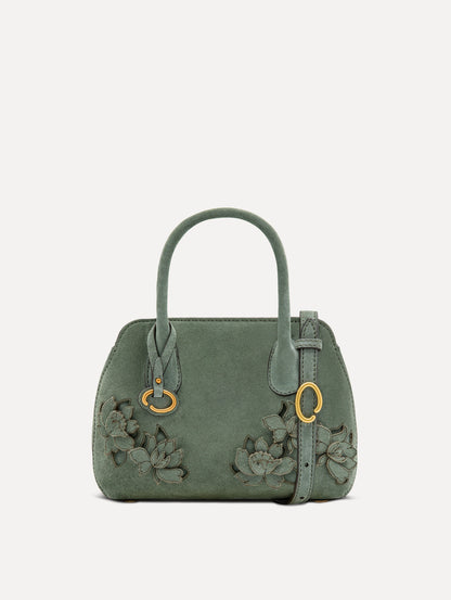 The Mini Ivy With Laser Cut Flowers in sage has a compartment with top handles and a removeable shoulder strap with various Oscar 'O' emblems on the hangtag and magnetic closure.