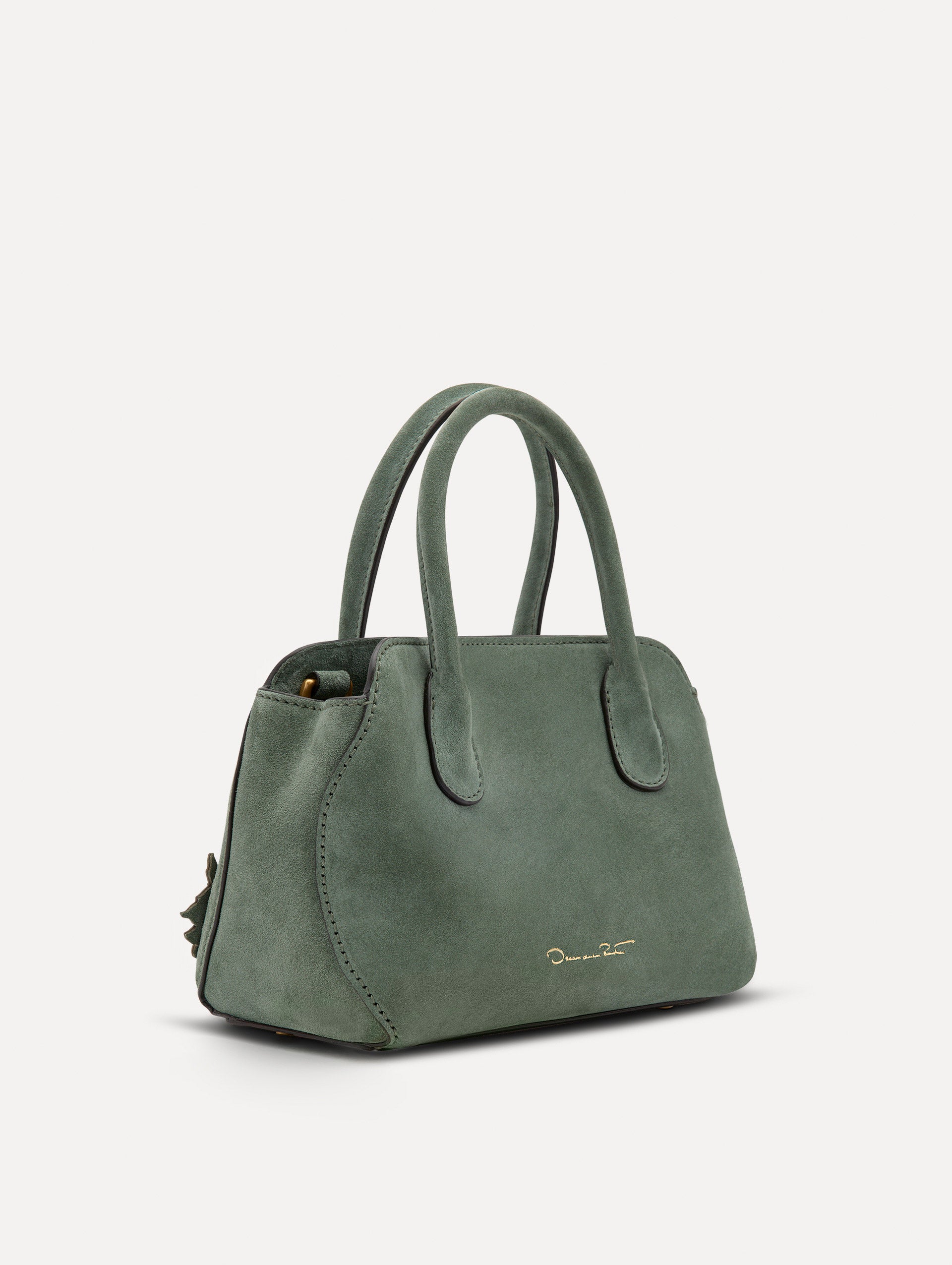 Side view of The Mini Ivy With Laser Cut Flowers in sage which has a compartment with top handles with magnetic closure.