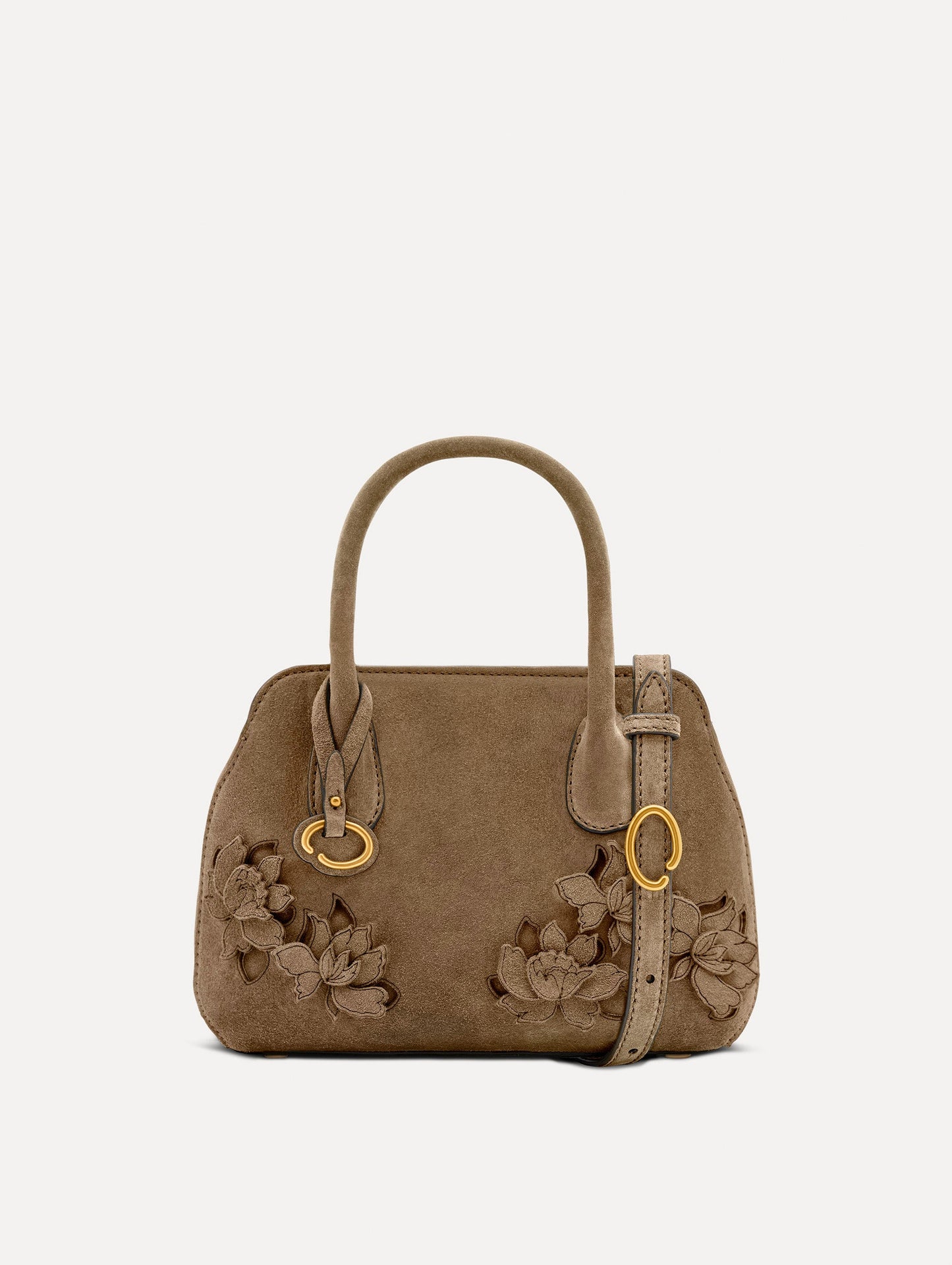 The Mini Ivy With Laser Cut Flowers in taupe has a compartment with top handles and a removeable shoulder strap with various Oscar 'O' emblems on the hangtag and magnetic closure.