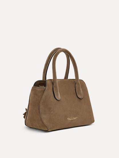 Side view of The Mini Ivy With Laser Cut Flowers in taupe features a compartment with top handles and magnetic closure.