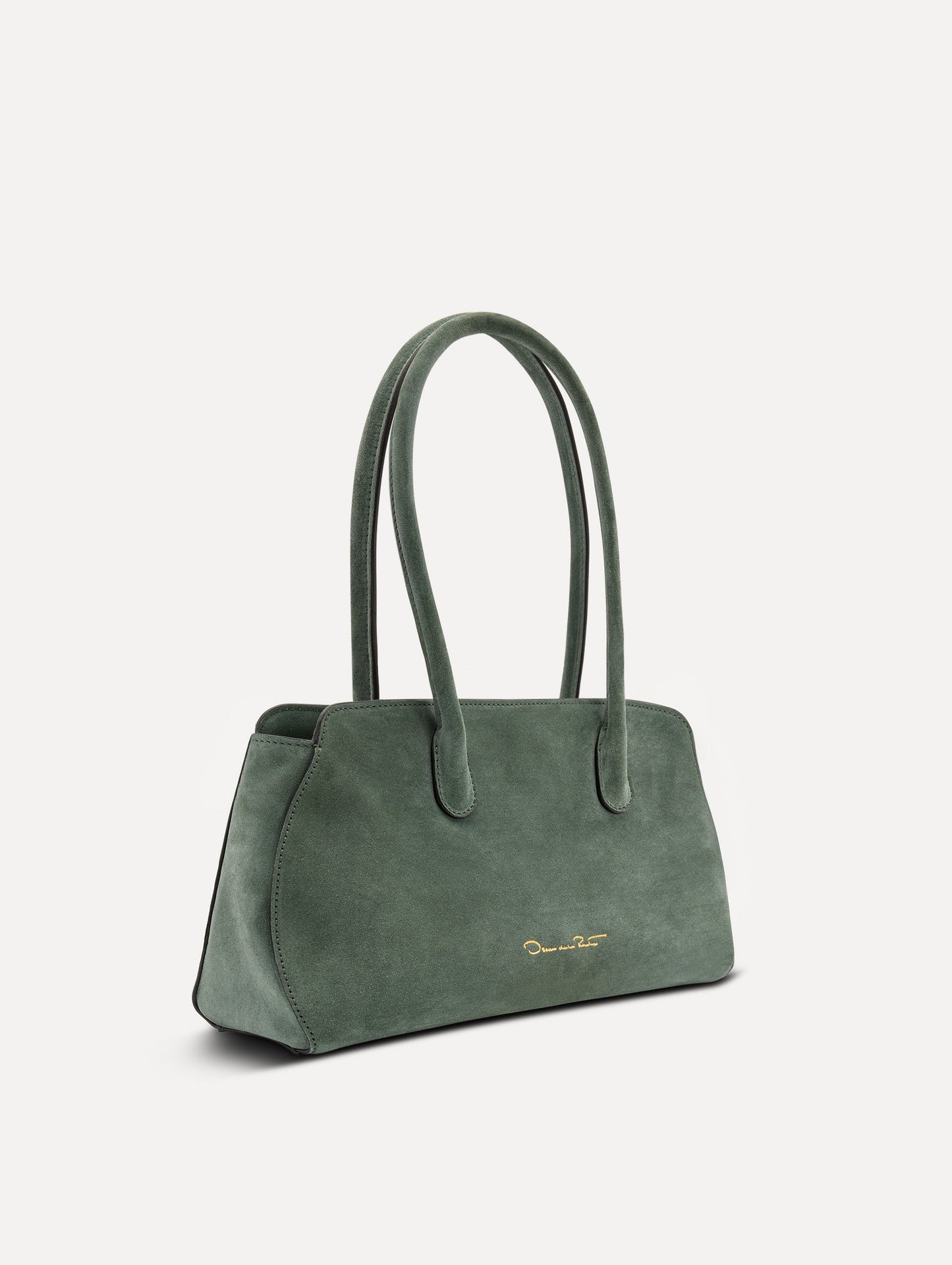 Side view of The Aster in sage which has gently curved sides which mimic the Oscar 'O.' Elongated top handles with gold hardware and an emblem-stamped tag.