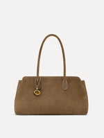 The Aster in taupe features decisive lines and gently curved sides that mimic the Oscar 'O.' Elongated top handles and gold hardware and an emblem-stamped tag.