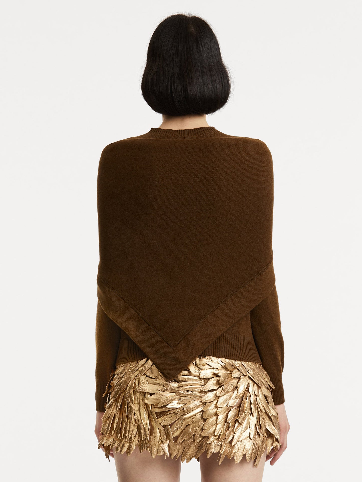 Back view of model wearing brown pullover with long sleeves and a crew neckline. Features matching shawl draped over shoulders.