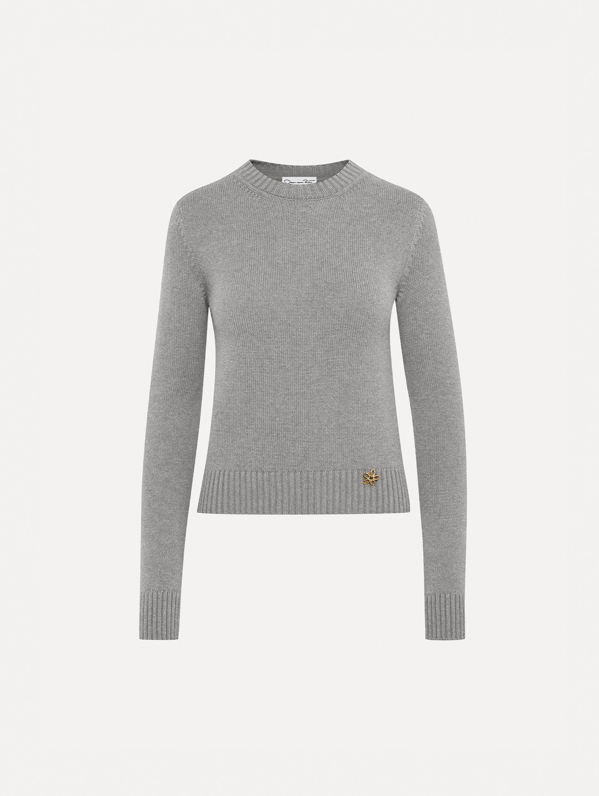 Light grey pullover with long sleeves and a crew neckline. Features gold 'O' Flower emblem made of the interlocking Oscar 'O'.