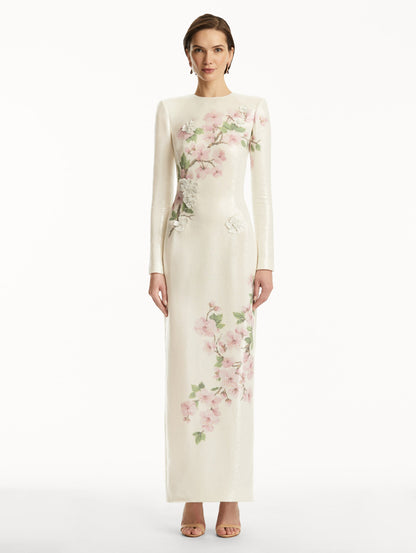 Model wearing white long sleeve sequin gown with pink cherry blossoms. Front View