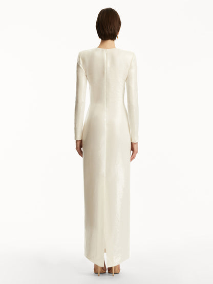 Model wearing white long sleeve sequin gown with pink cherry blossoms. Back View