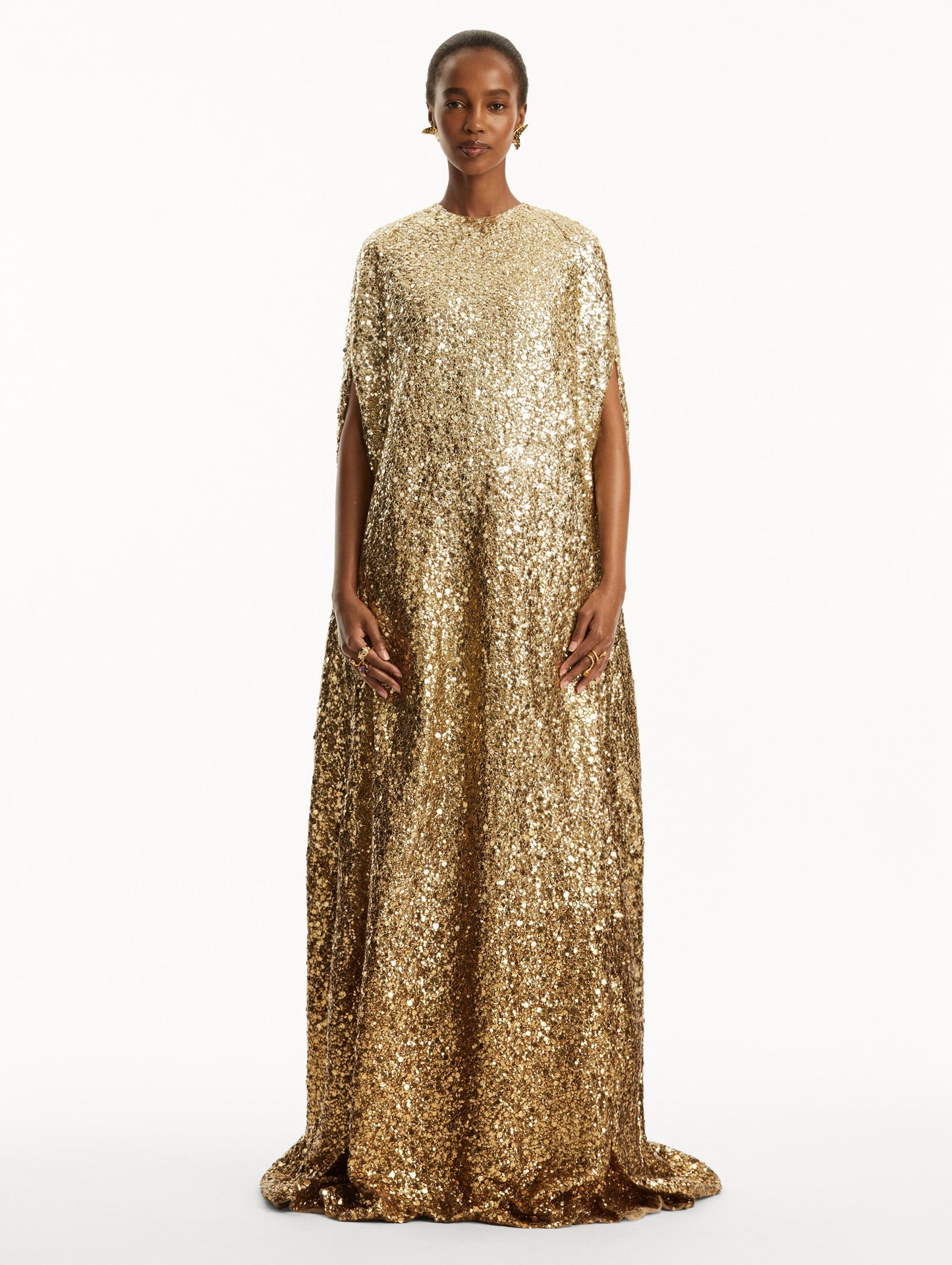 Model wearing ombre gold sequin embroidered caftan. Front view