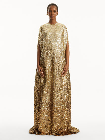 Model wearing ombre gold sequin embroidered caftan. Front view