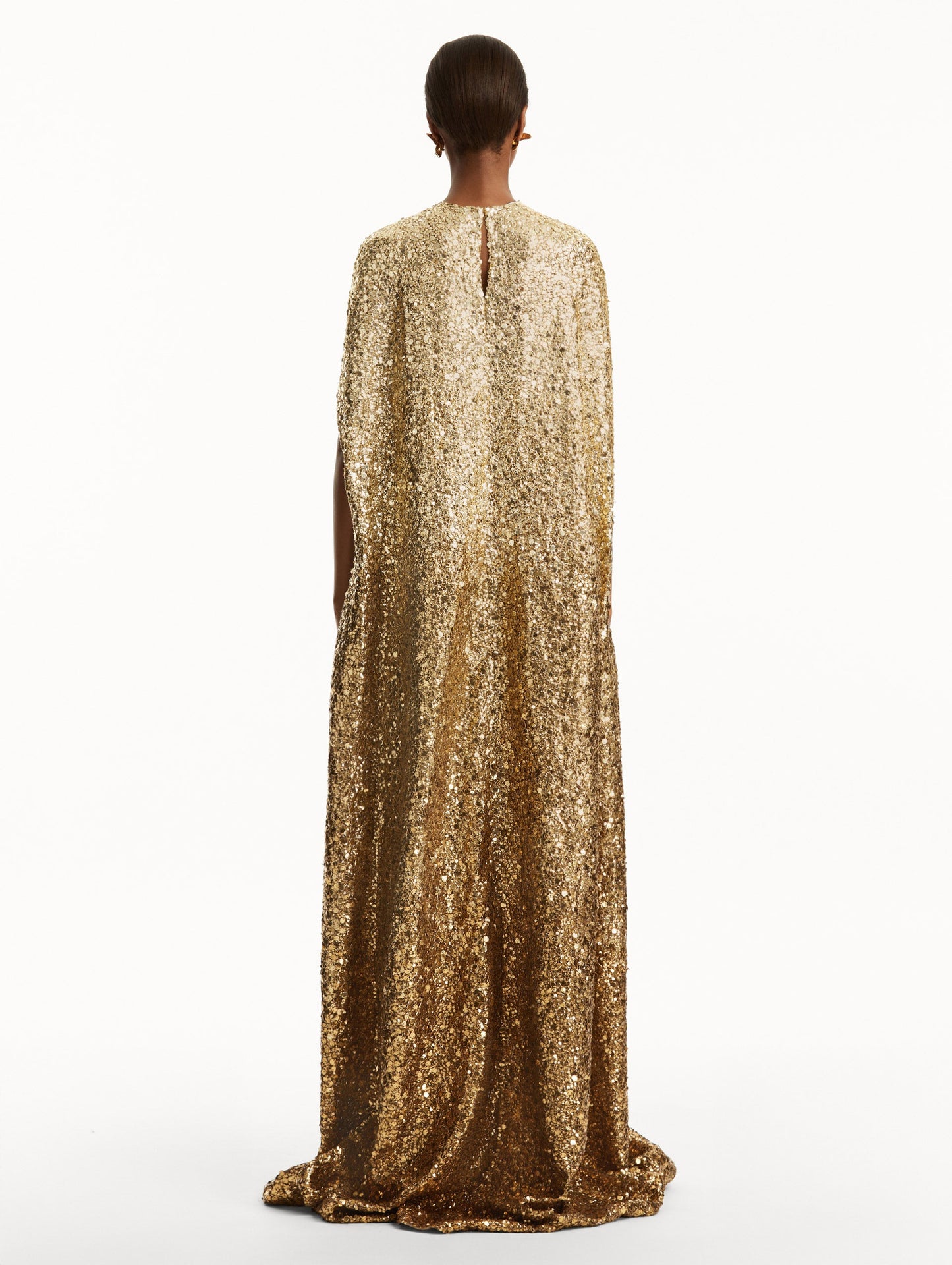 Model wearing ombre gold sequin embroidered caftan. Back view