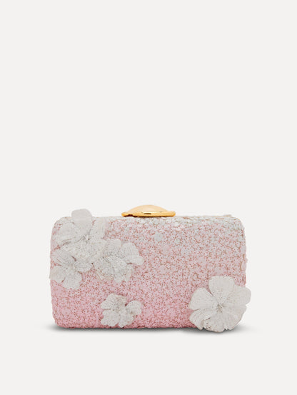 A clutch embellished with pink stones and three-dimensional white flowers attached. Front view.