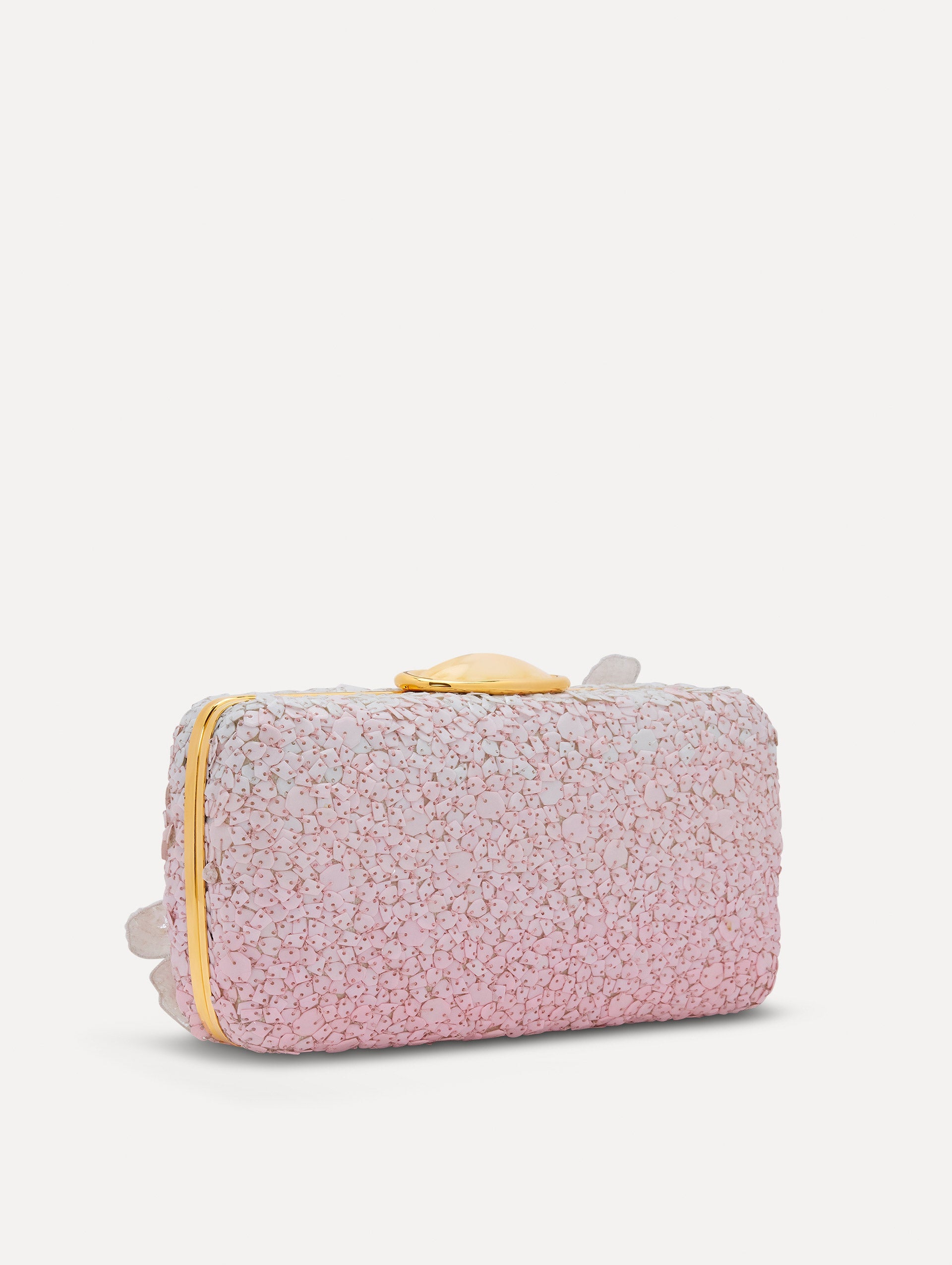A clutch embellished with pink stones and three-dimensional white flowers attached. Side back view.