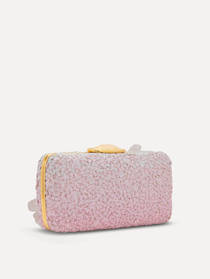 A clutch embellished with pink stones and three-dimensional white flowers attached. Side back view.