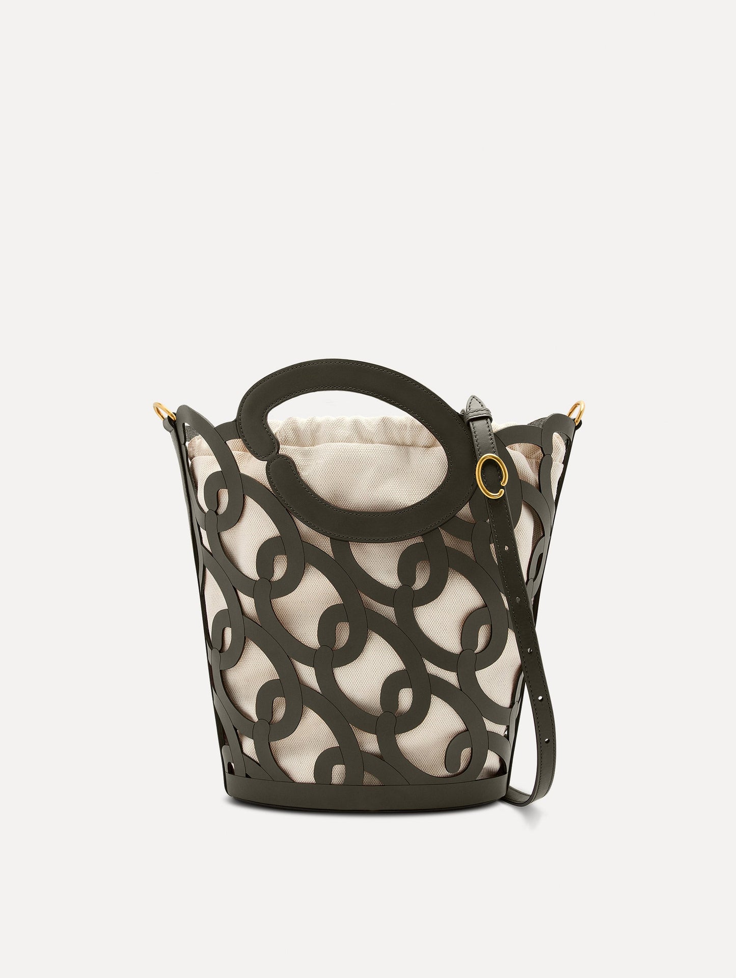 The Oscar chain link bucket tote in olive green with a large o forming the top handle and detachable shoulder strap, paired with an ombre floral dress. Front View.
