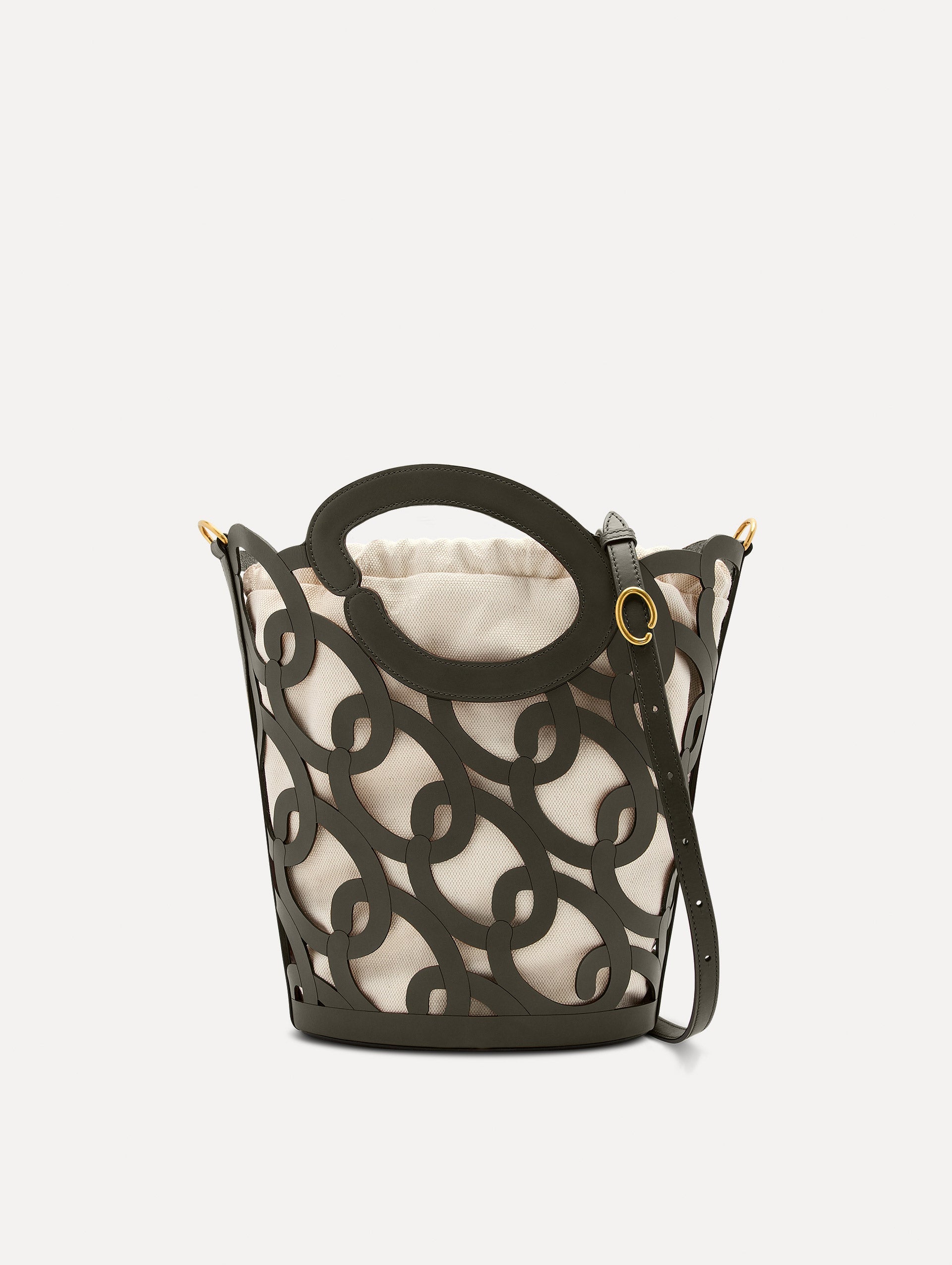 The Oscar chain link bucket tote in olive green with a large o forming the top handle and detachable shoulder strap, paired with an ombre floral dress. Front View.