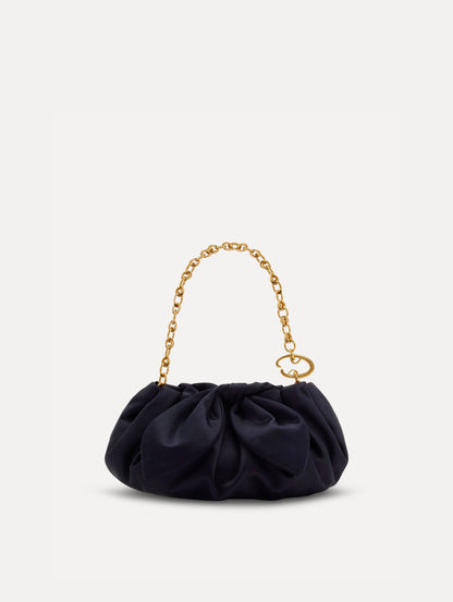 Small satin clutch in taupe with a bow detail on the top. Front View.