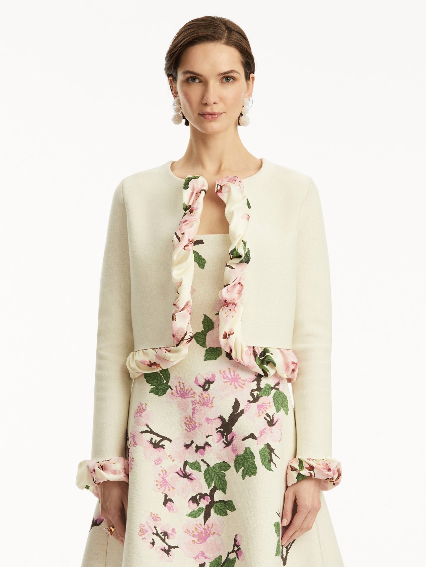 White cardigan with pink bubble twist trim printed with cherry blossoms, paired with cherry blossom tweed dress. Front view