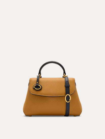 The Mini Poppy Handbag in Honey with Black Top Handle. Adorned with Oscar de la Renta's signature O at the ornamental bag tag. Front View