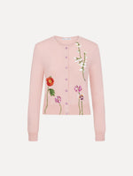 The model is wearing the mixed botanical threadwork cardigan in the color blush with floral detailing.