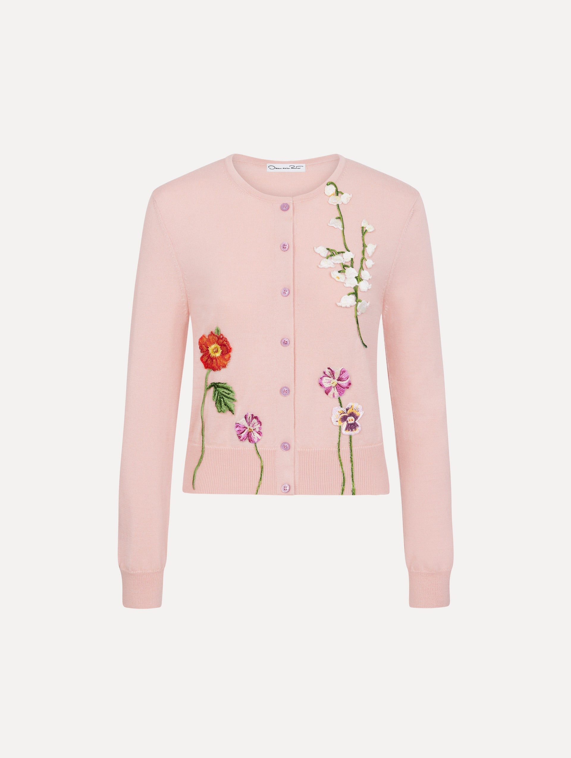 The model is wearing the mixed botanical threadwork cardigan in the color blush with floral detailing.