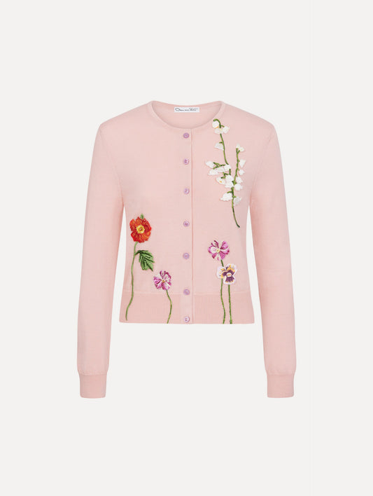 The model is wearing the mixed botanical threadwork cardigan in the color blush with floral detailing.