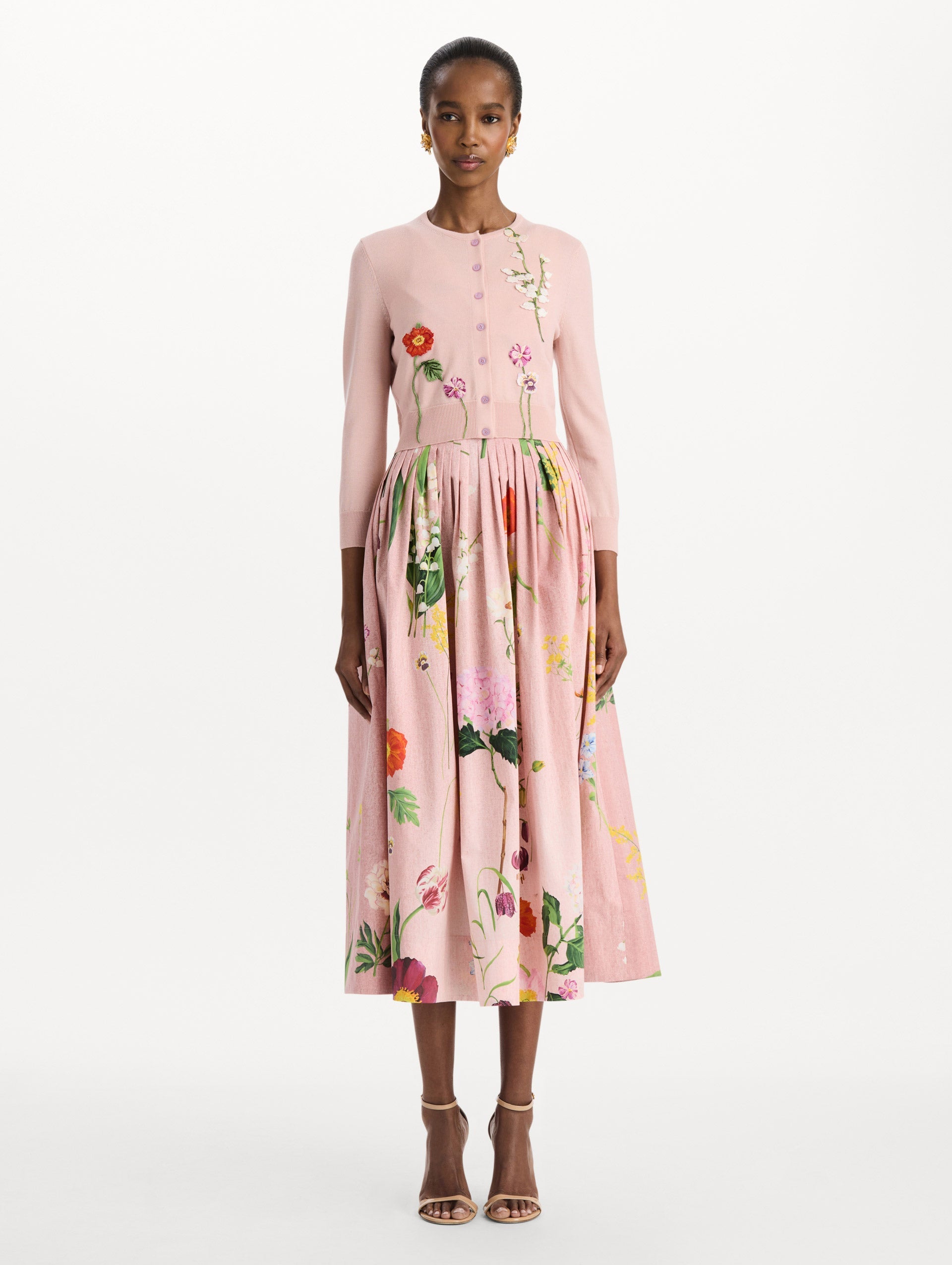 The model is wearing the mixed botanical threadwork cardigan in the color blush with floral detailing. Front view.